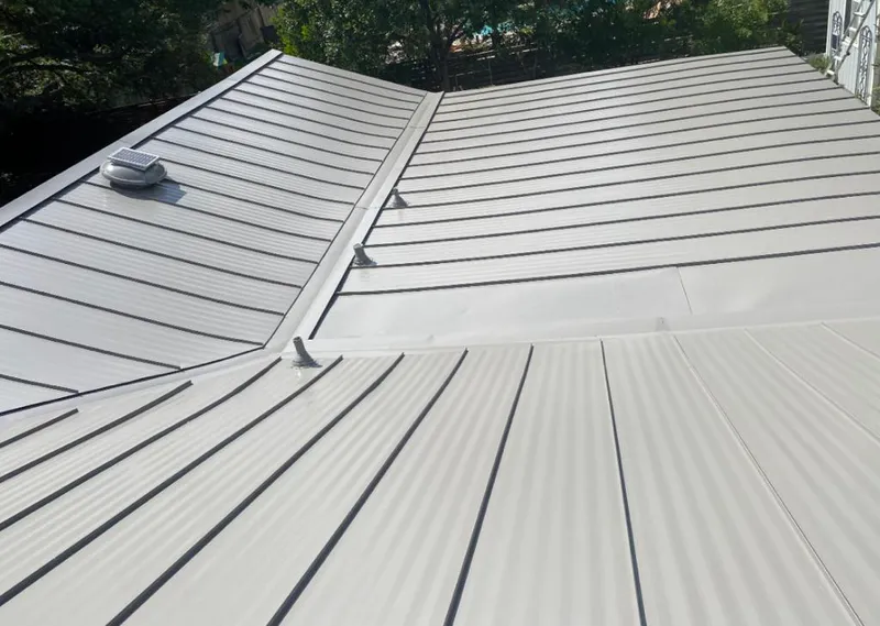 Solar attic fan installed on a metal roof for Roof Ventilation in Reserve
