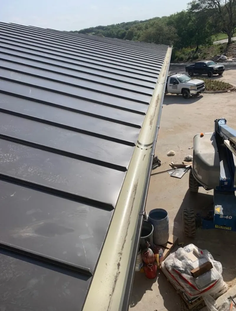 Standing seam panel and gutter detail on a metal roofing jobsite in Reserve